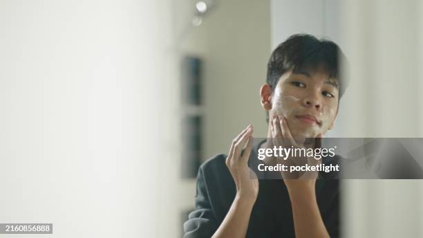teenager washing face skin by foam cleanser. - kid acne stock pictures, royalty-free photos & images