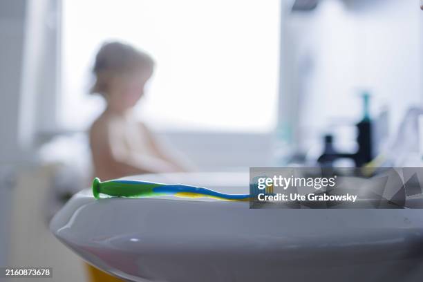 In this photo illustration a child is in the bathroom to brush its teeth on July 10, 2024 in Bonn, Germany.