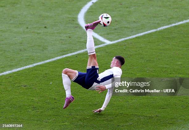 General view as Phil Foden of England attempts a shot with an overhead kick whilst under pressure from Ricardo Rodriguez of Switzerland during the...