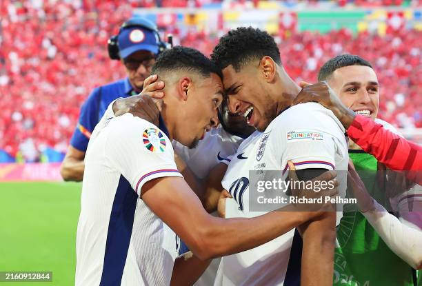 Trent Alexander-Arnold of England celebrates scoring the winning penalty with teammate Jude Bellingham of England during the UEFA EURO 2024...