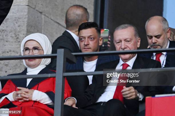 Former footballer, Mesut Oezil, looks on from the stands as he sits in the row behind Recep Tayyip Erdogan, Turkish President, prior to the UEFA EURO...