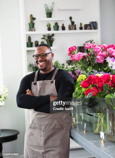 african-american man working in flower and gift shop - gift shop stock pictures, royalty-free photos & images