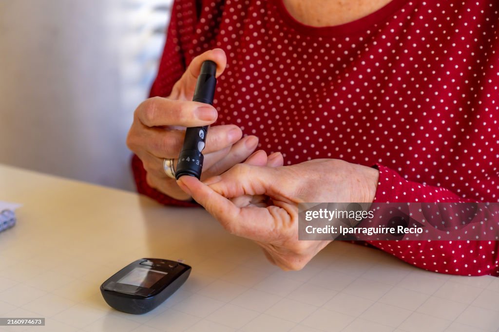 A woman using blood sugar testing device
