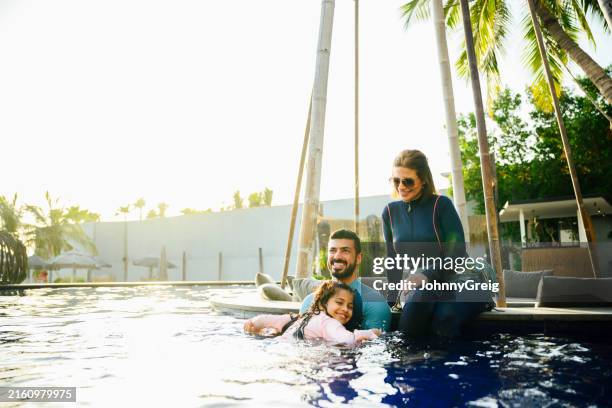 young saudi family enjoying jeddah resort swimming pool - jeddah stock pictures, royalty-free photos & images