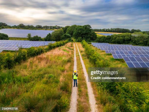 aerial view of maintenance engineer working at the solar farm - solar power station stock pictures, royalty-free photos & images