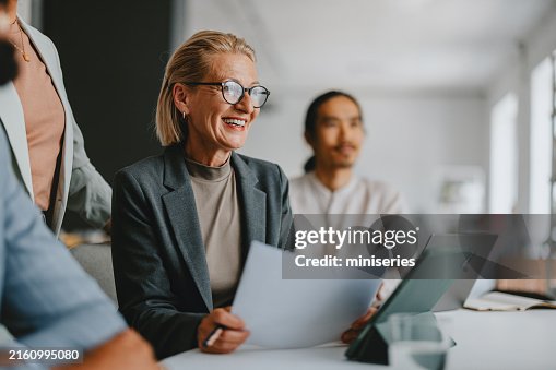 Senior Businesswoman Leading Team at Office Meeting Senior Businesswoman Leading Team at Office Meeting