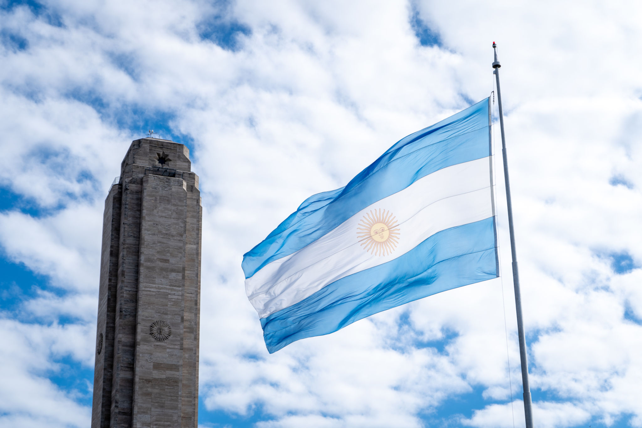 Argentine flag flying in front of the flag monument in the city of Rosario. Argentine flag flying in front of the flag monument in the city of Rosario.