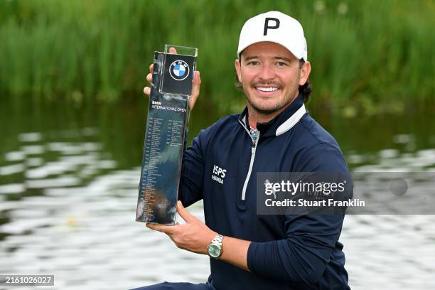 Ewen Ferguson of Scotland poses with the trophy after winning the BMW International Open on the 18th hole during day four of the BMW International...