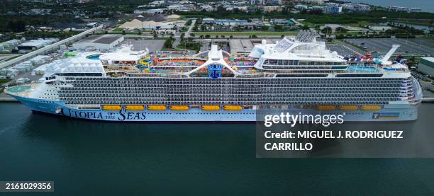 This aerial picture taken on July 11, 2024 shows Royal Caribbean's "Utopia Of The Seas," billed as the world's largest cruise ship, docked at Port...