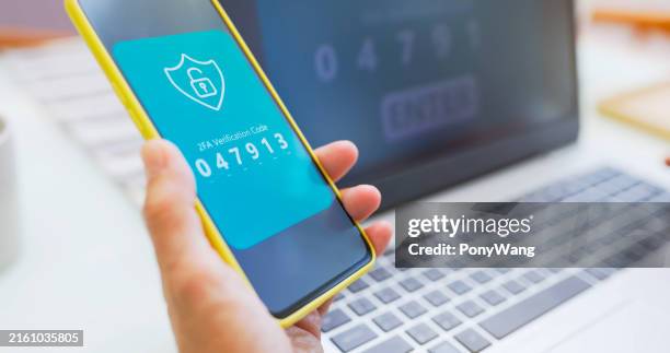 asian elderly hands enter 2fa - digitale authenticatie stockfoto's en -beelden