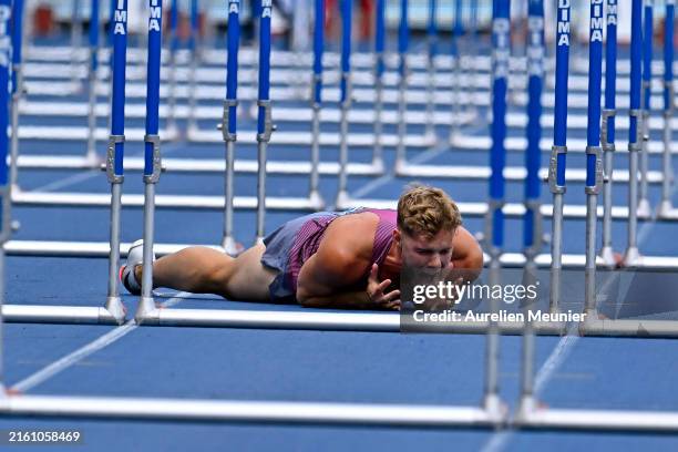 Kevin Mayer of France reacts after his injury as he competes in the 110m hurdles of the triathlon during the 2014 Diamond League at Stade Charlety on...