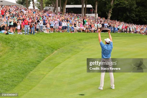 Davis Thompson of the United States celebrates with the trophy after winning the John Deere Classic at TPC Deere Run on July 07, 2024 in Silvis,...