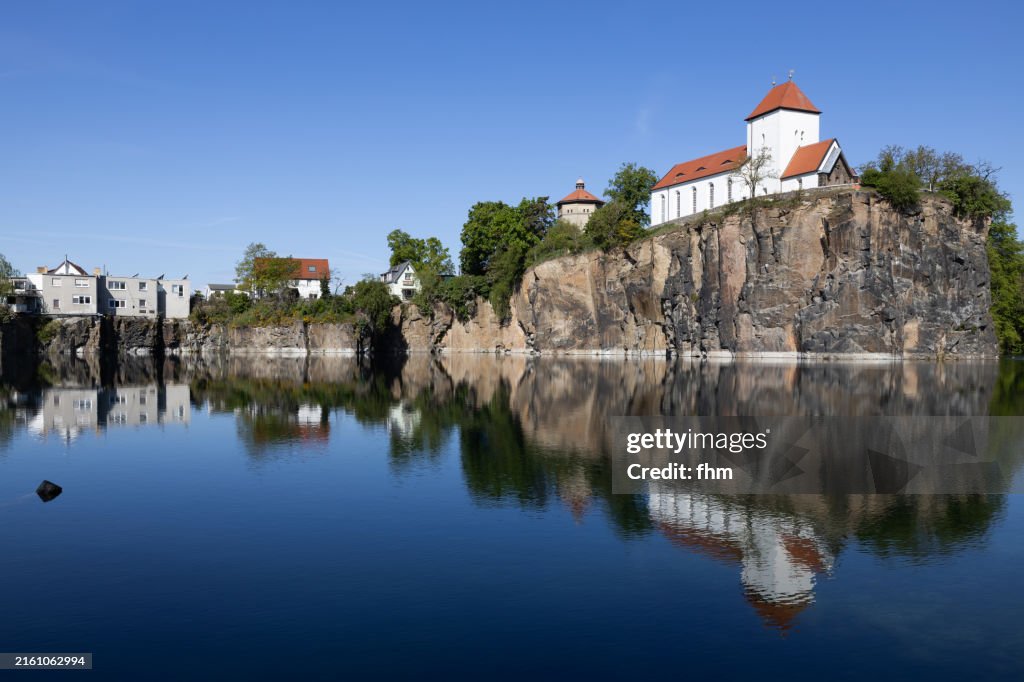 Travel destination: Historic church on a mountain next to an old quarry, today a lake (Beucha, Saxony/ Germany)