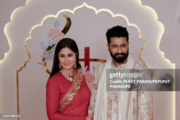 Bollywood actor Vicky Kaushal with his wife and actress Katrina Kaif pose for photos as they arrive to attend the wedding ceremony of billionaire...