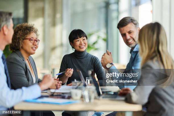 happy multiracial business team talking on a meeting in the office. - riunione foto e immagini stock