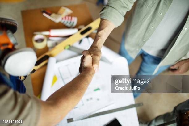 home owner shaking hands with construction worker - contracting stock pictures, royalty-free photos & images