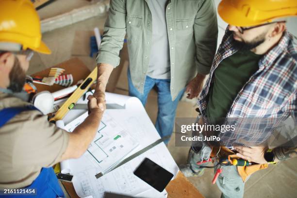 home owner shaking hands with construction worker - contracting stock pictures, royalty-free photos & images