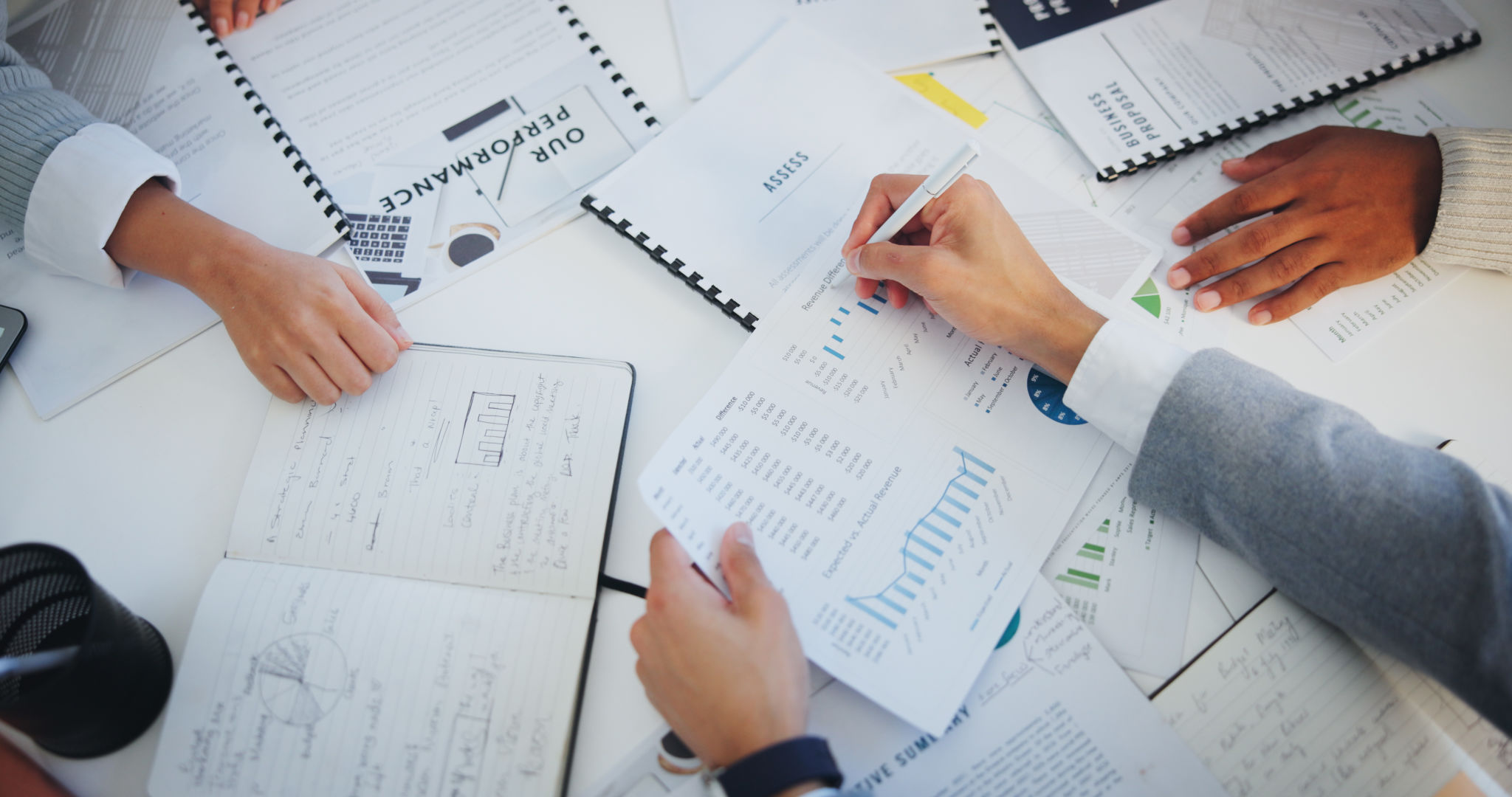 Hands, business people and group with documents, above and circle with writing, graphs or notes for finance. Staff, audit and performance review for stats, charts or notebook with paperwork in office Hands, business people and group with documents, above and circle with writing, graphs or notes for finance. Staff, audit and performance review for stats, charts or notebook with paperwork in office