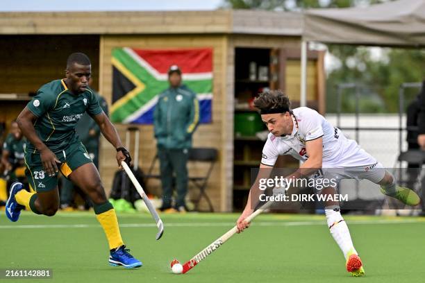Belgium's Arno Van Dessel and South African Samkelo Mvimbi pictured in action during a friendly hockey match between the Belgian Red Lions and South...