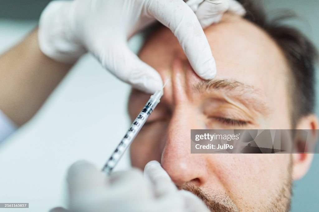 Filler injection for male face in beauty clinic