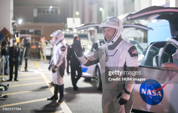 SpaceX Crew-4 mission - NASA astronaut Kjell Lindgren waves to family and friends as he and crew mates, wearing SpaceX spacesuits, depart the Neil A....