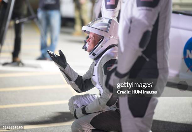 SpaceX Crew-4 mission - NASA astronaut Robert Hines gestures to family and friends as he and crew mates, wearing SpaceX spacesuits, depart the Neil...