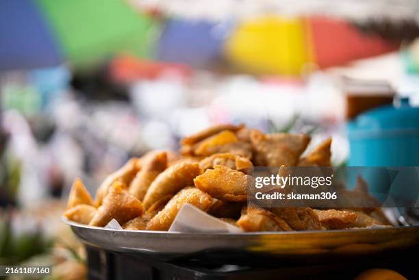 fried samaosas, a fried indian snack, selling at morning market in thailand - samosa stock pictures, royalty-free photos & images