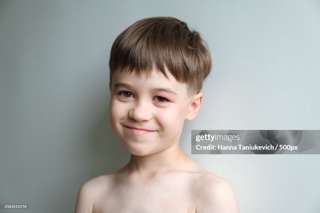 Portrait of smiling boy against wall