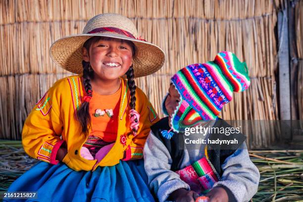 girl and boy on uros floating island, lake tititcaca, peru - inca stockfoto's en -beelden