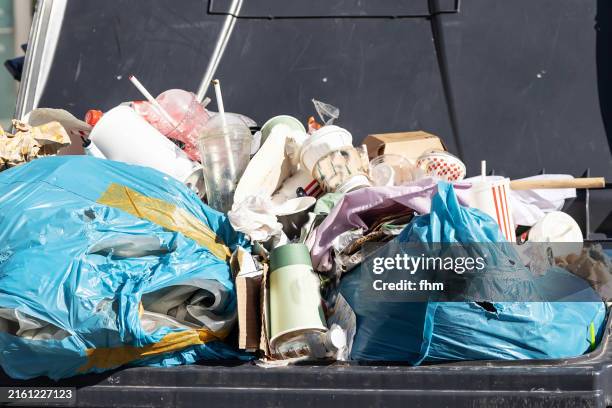 overfilled dustbin - skip bin stock pictures, royalty-free photos & images