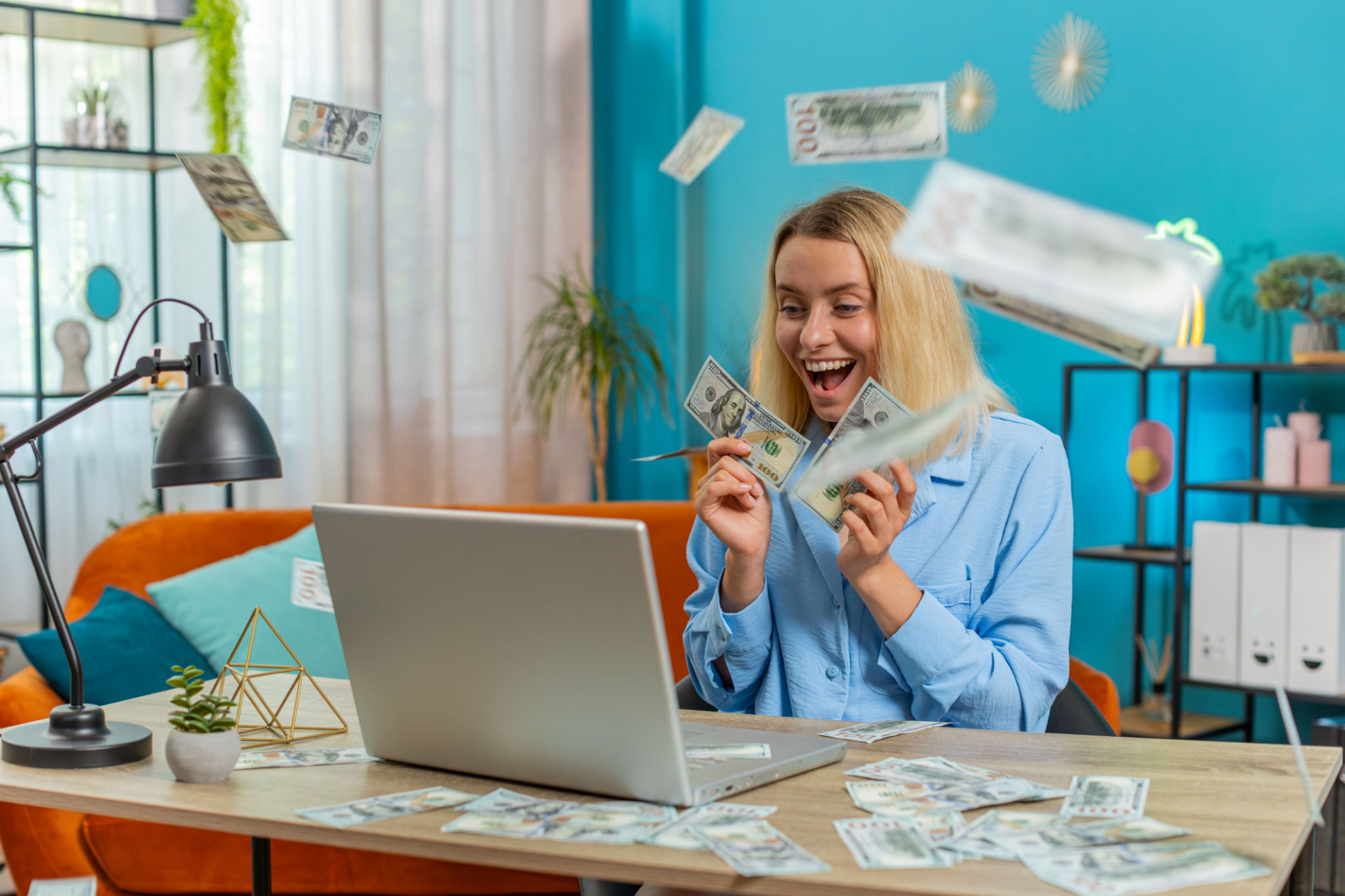 Money cash dollar rain falling on woman using laptop celebrating success play casino online game Money cash dollar rain falling on woman using laptop celebrating success play casino online game