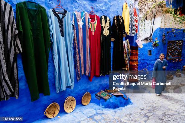 Man standing outside a souvenirs shop in the blue medina.