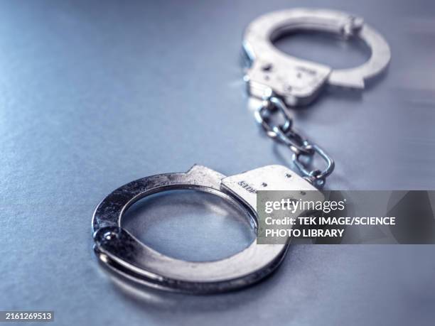 handcuffs - handcuffs stock pictures, royalty-free photos & images