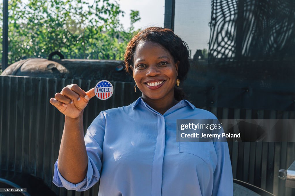 Smiling African-American woman with an "I Voted" Sticker for a Presidential, Senatorial, Congressional, or local election