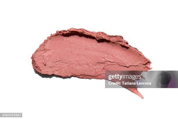 beige pastel colored lipstick swatch isolated on solid white background. fashion, beauty products industry. macro photography, top view, close up - colorete fotografías e imágenes de stock