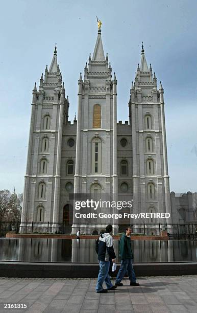 Bystanders look at the Mormon Salt Lake Temple March 19, 2003 in Salt Lake City, Utah. The story of the Lafferty brothers, who committed murder which...