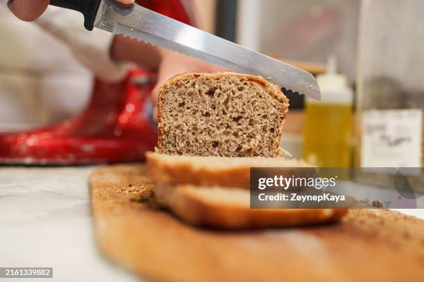 slicing whole wheat bread at the bakery - whole wheat stock pictures, royalty-free photos & images