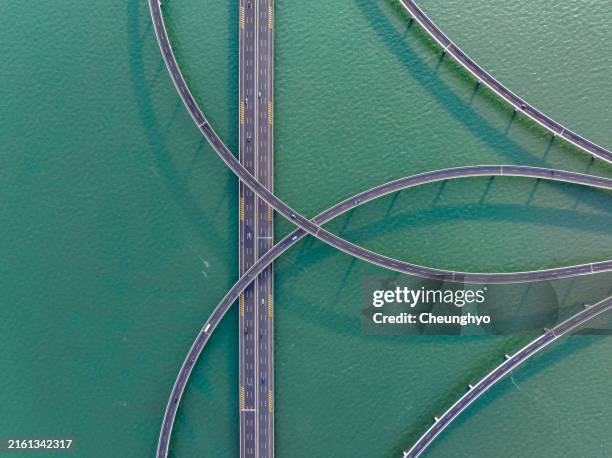 drone aerial view of jiaozhou bay bridge of qingdao, shandong province, china - échangeur photos et images de collection