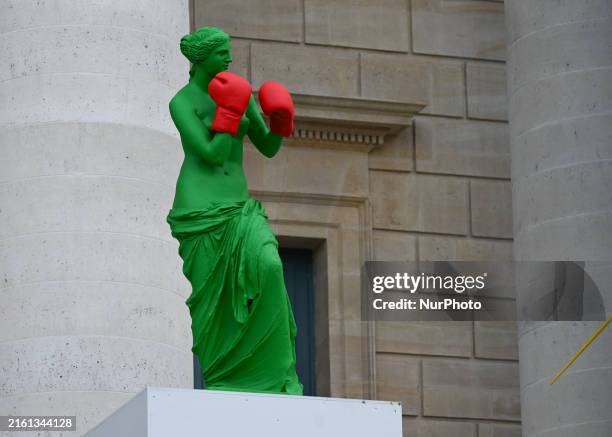 Stairs to the Grande Arche adorned with Olympic-themed paintings, celebrating the upcoming Paris 2024 Olympic and Paralympic Games, on July 13 in the...
