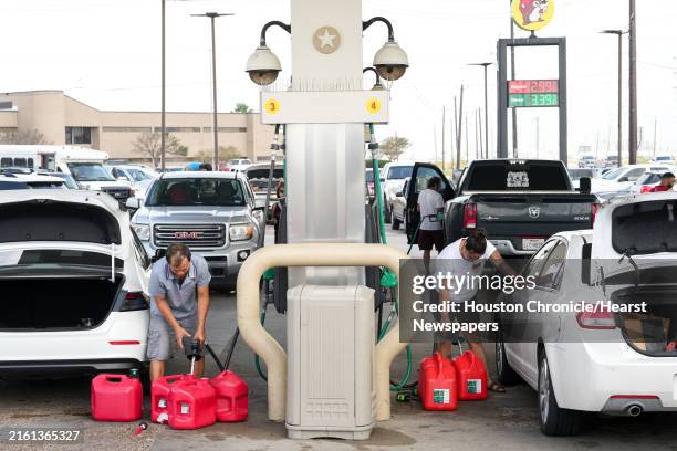 People fill gas cans the day after Hurricane Beryl made landfall nearby Tuesday, July 9 in Freeport.