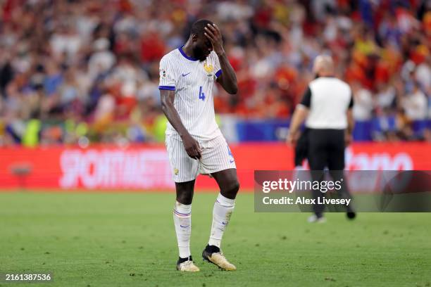 Dayot Upamecano of France looks dejected as he leaves the field after defeat to Spain during the UEFA EURO 2024 Semi-Final match between Spain and...