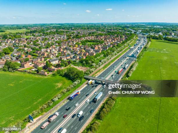 drone view of traffic on the m1 motorway in england - environmental conservation stock pictures, royalty-free photos & images