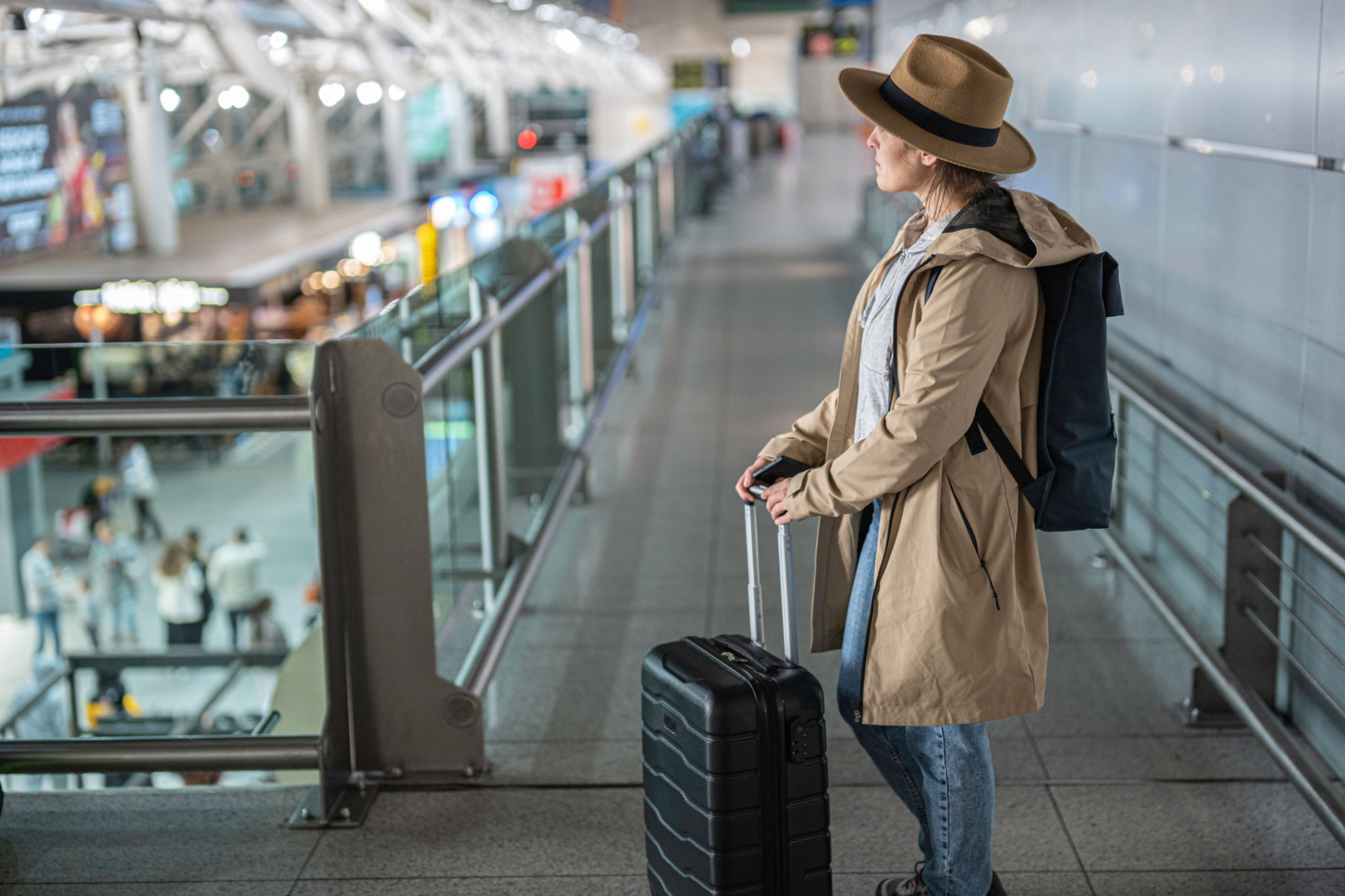 Travel Journey. Woman Waits with Luggage at the Airport. Travel Journey. Woman Waits with Luggage at the Airport.