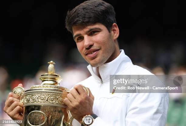 Carlos Alcaraz with the trophy after winning his Gentlemen's Singles Final match against Novak Djokovic during day fourteen of The Championships...