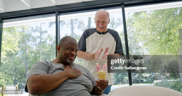 man bashfully marking 30 days sober in residential addiction rehab - drug addiction rehabilitation center stock pictures, royalty-free photos & images