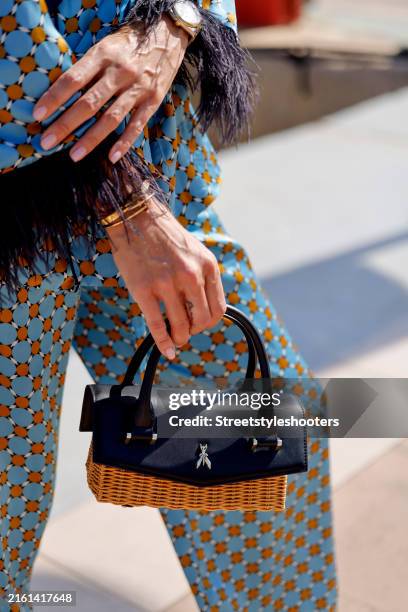 Annika Gassner, wearing a blue patterned suit by Zara and a black and beige bag by Patrizia Pepe, seen on July 9, 2024 in Palma de Mallorca, Spain.