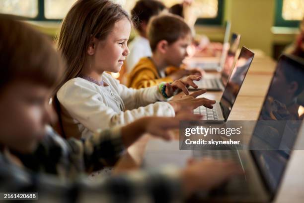 school kids using laptop on a class at elementary school. - classroom laptop stock pictures, royalty-free photos & images