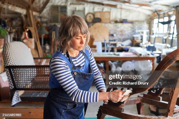 an upholsterer polishing a wooden chair frame - antique stock pictures, royalty-free photos & images