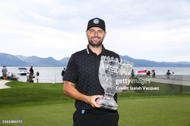 Former tennis player Mardy Fish poses with the trophy after winning the championship on day three of the 2024 American Century Championship at...
