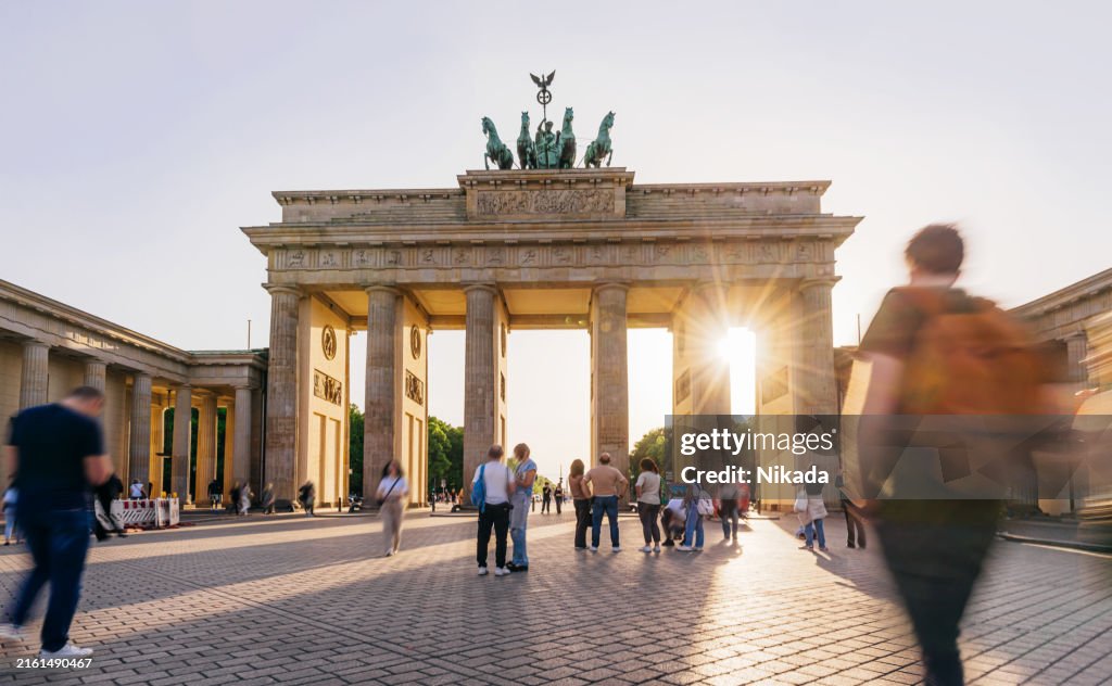 Sunset Glow at Brandenburg Gate in Berlin, Tourists Walking